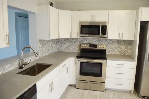 Kitchen remodel with light cabinets, tile backsplash and recessed lighting