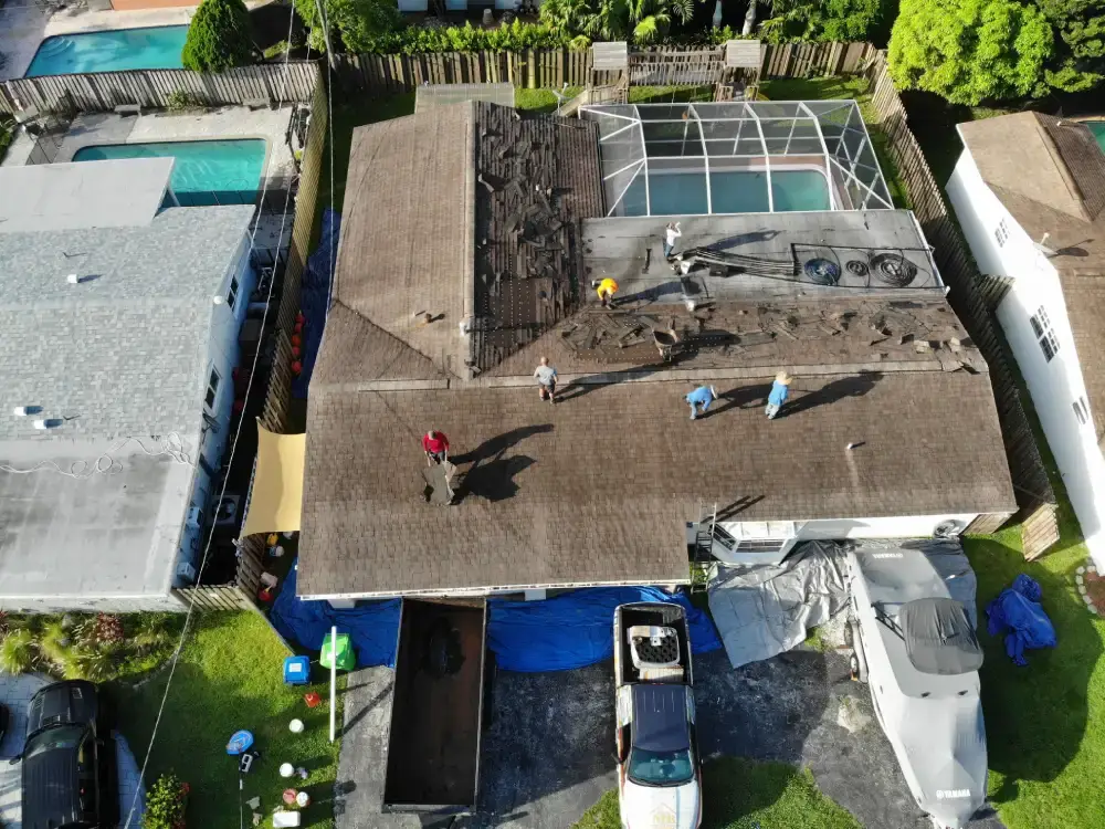 Aerial view of a Broward County, Florida suburban neighborhood with a roof replacement in progress