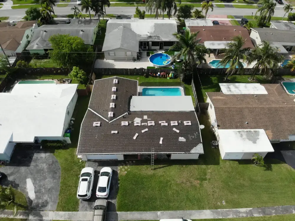 Aerial view of a Davie, Florida neighborhood with a roof replacement in progress