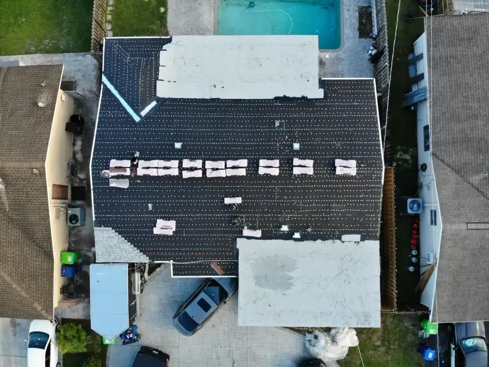 Aerial view of a Deerfield Beach, Florida neighborhood with a roof replacement in progress