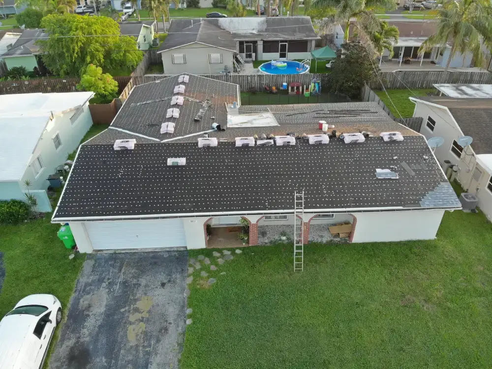 Aerial view of a South Florida neighborhood with a roof replacement underway